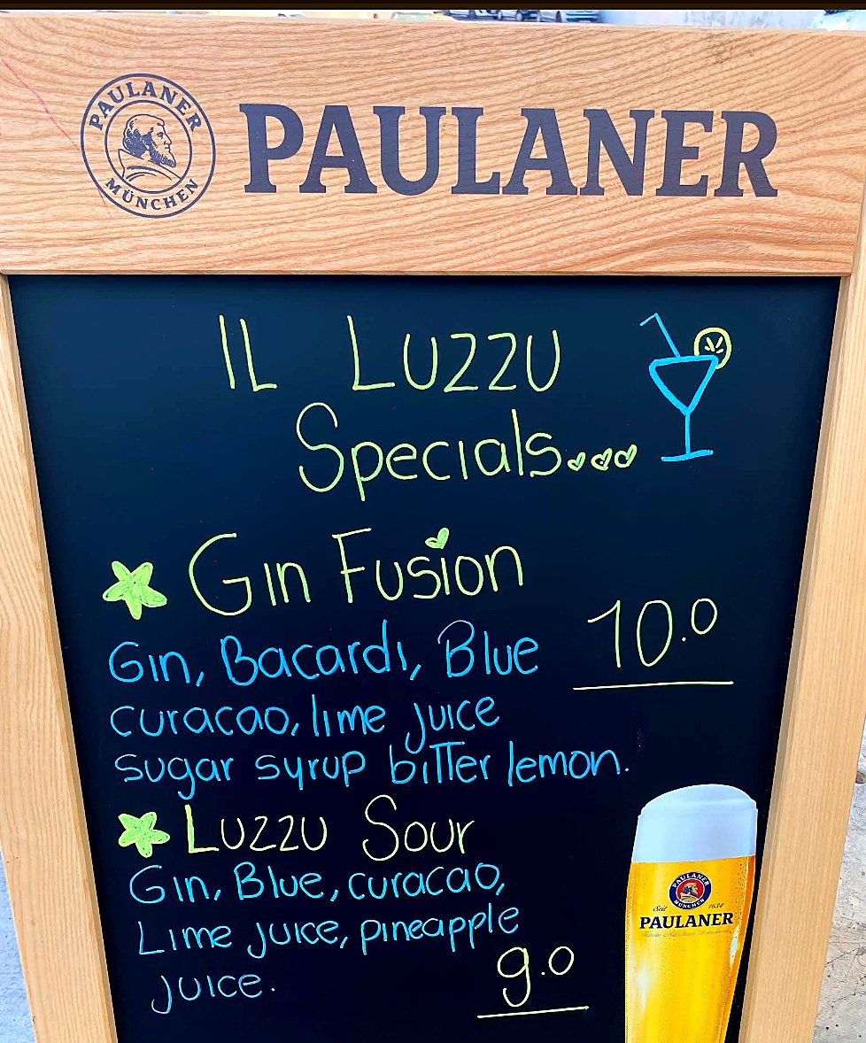 Il-Luzzu chalkboard cocktail specials.